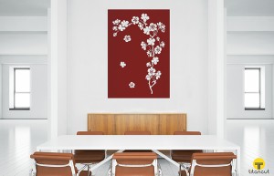 Brown metal panel with cherry branch pattern, on a wall in the middle of a white office, behind office table and six chairs 