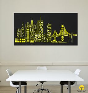 Laser cut metal panel with San Francisco cityscape pattern, on a white wall, behind white office table and 3 chairs